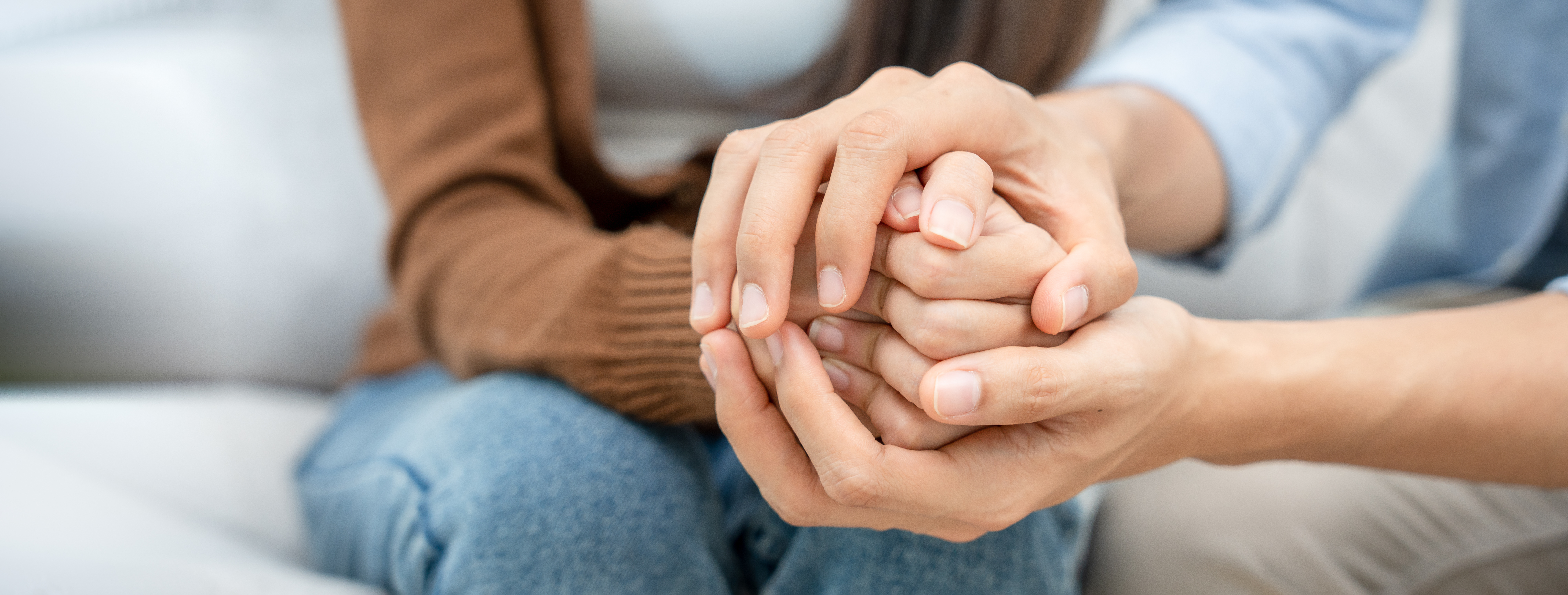 Couples hold hands to support each other while discussing family