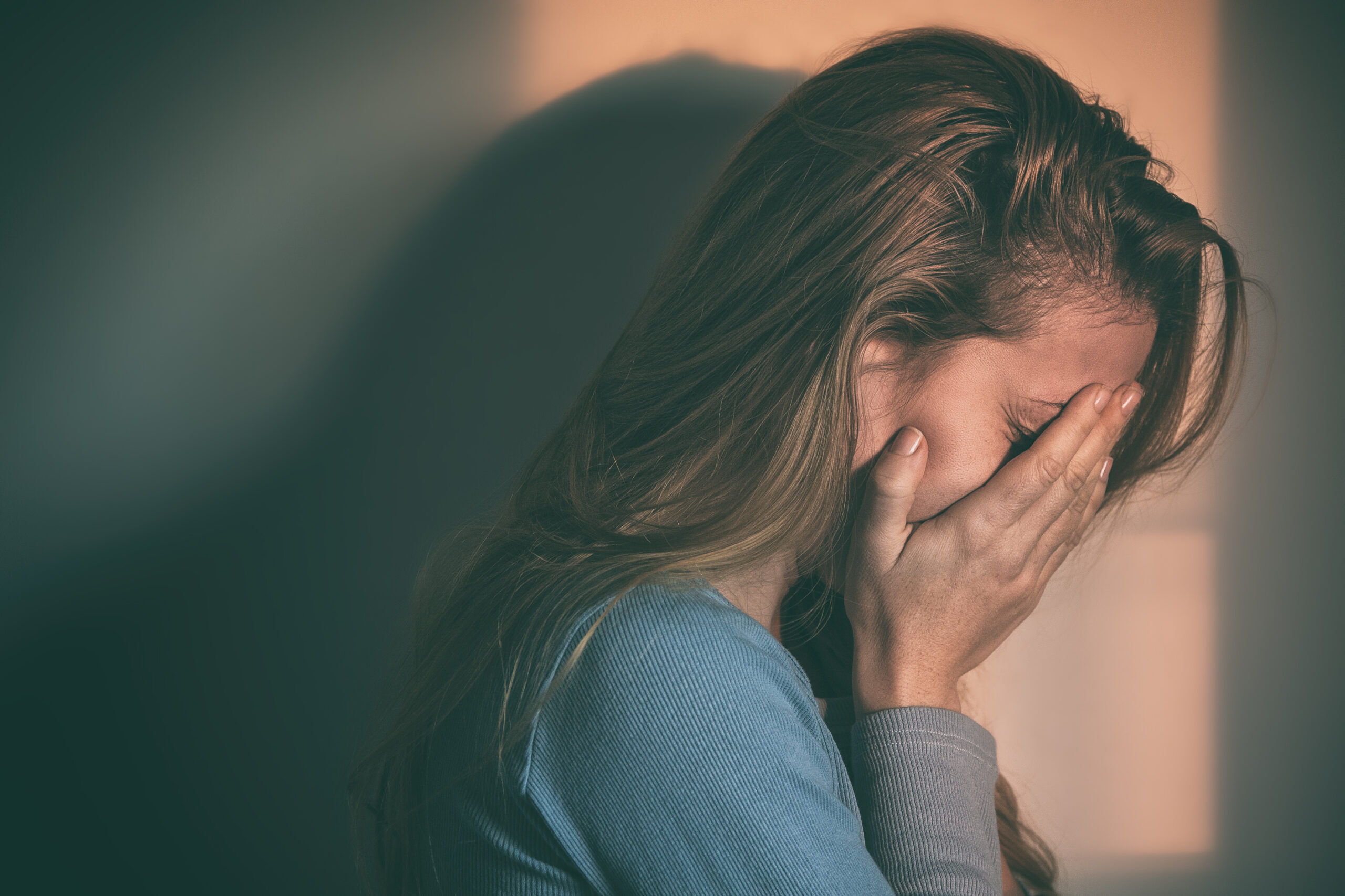 sad woman with face in hands